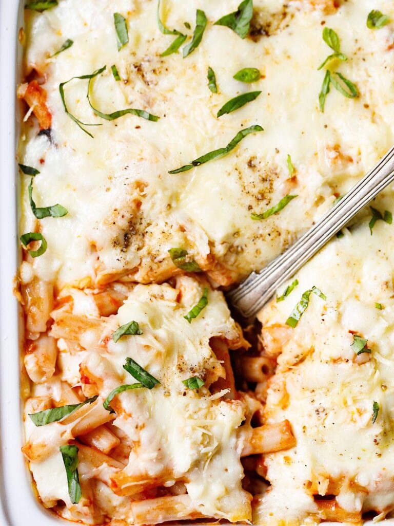 top shot of baked ziti casserole with a spoon.