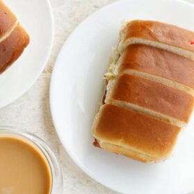 bun maska on white plate with a side of chai with text layovers.