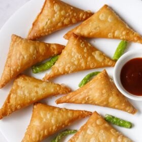 Crispy onion samosa with green chillies with text layovers.