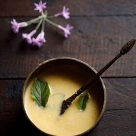 Bowl of panchamrut with holy basil leaves with text layovers.