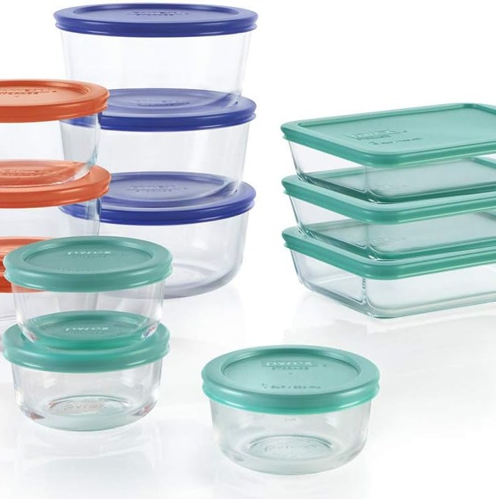 A set of red, blue, and green-lidded pyrex storage in various shapes and sizes.