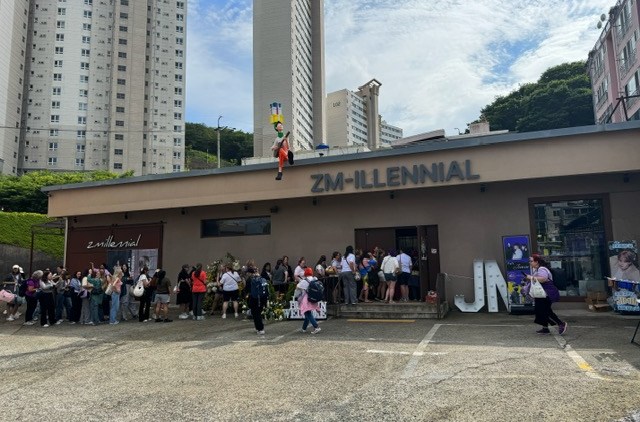 a crowd stands in line for ZM-Illenial cafe in Busan, South Korea