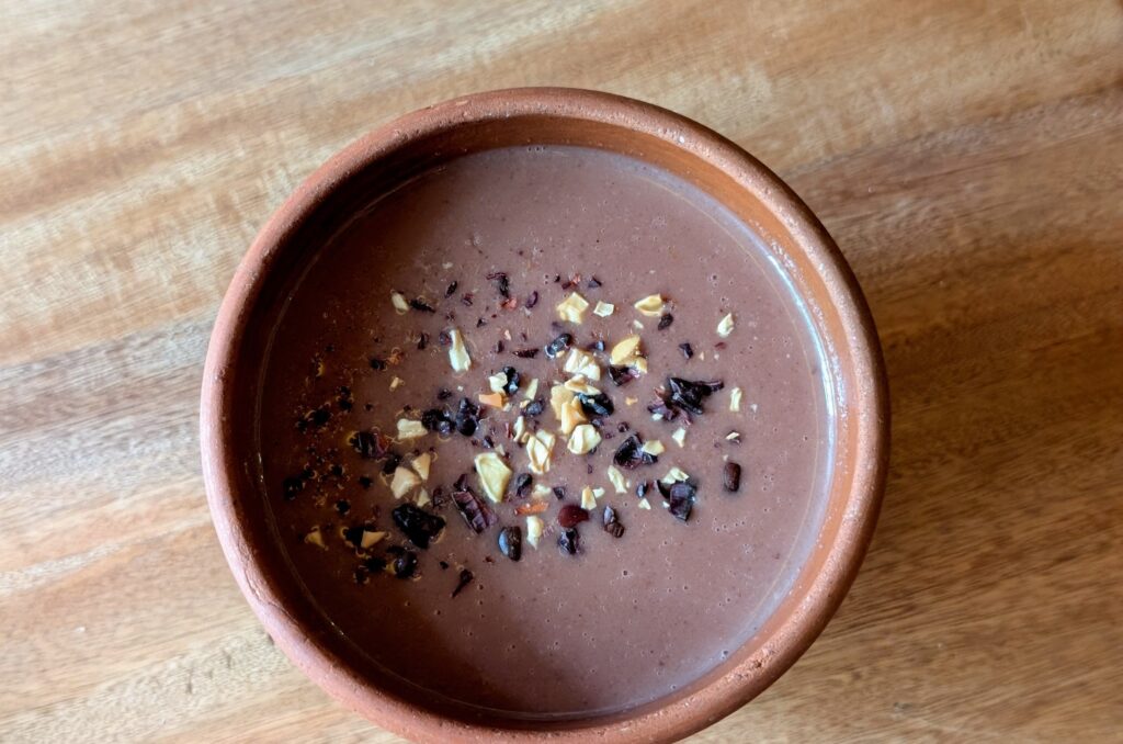 Atole champurrado in a clay vessel, seen from the top.