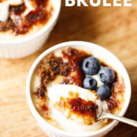 Crème Brûlée with caramel top, custard spoonful, and blueberries, with text layovers.
