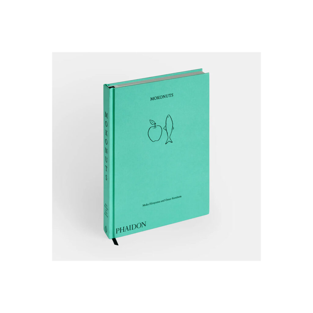 A book with teal cover and line drawings of an apple and fish.