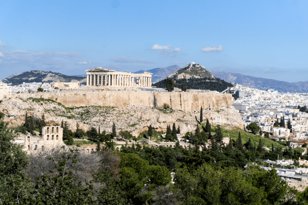 The Parthenon on the Acropolis, with the city of Athens and greenery stretched out below.